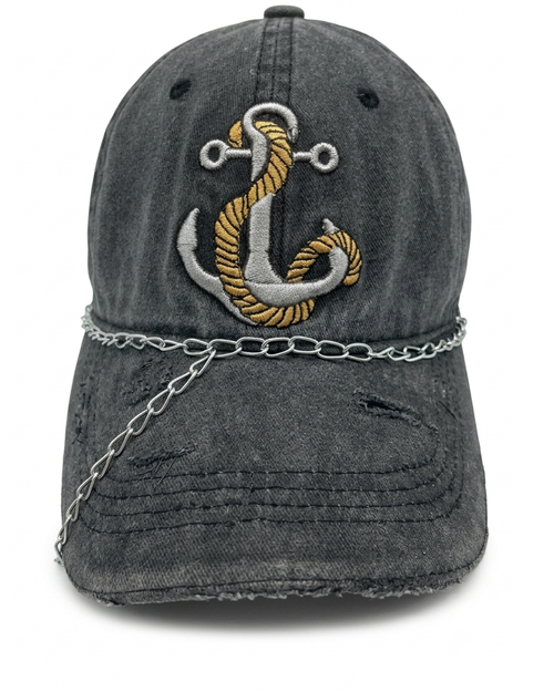 A distressed dark gray washed baseball cap featuring a large embroidered anchor on the front with gold and silver thread, a silver chain draped across the brim, and distressed details on the brim.