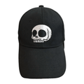 A black baseball cap featuring a white embroidered skull design on the front, set against a plain white background.