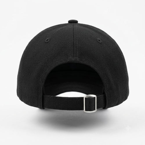 The back view of a black baseball cap with an adjustable black fabric strap and a silver metal buckle, shown on a light gray background.