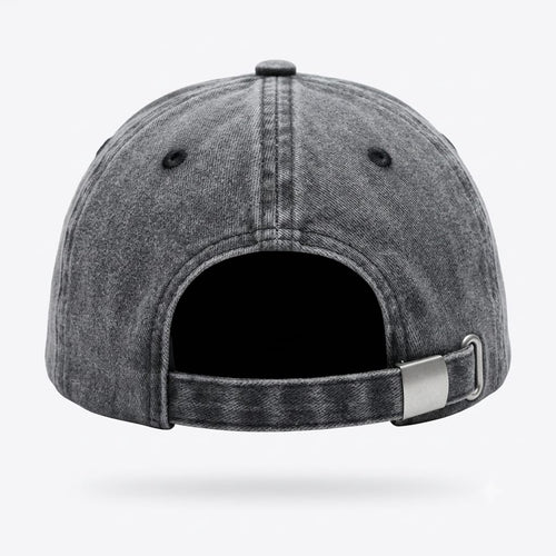 The back view of a washed black denim baseball cap with an adjustable strap and metal slider, shown on a light gray background.